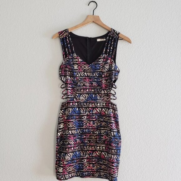 Super cute tribal printed boducon dress with caged rib detail. In very good cond